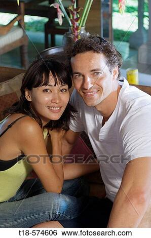 couple sitting and posing on bench View Large Photo Image Stock Photograph - couple sitting and posing on bench. Fotosearch