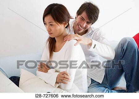 Couple Sitting on sofa View Large Photo Image Stock Photograph - Couple Sitting on sofa. Fotosearch
