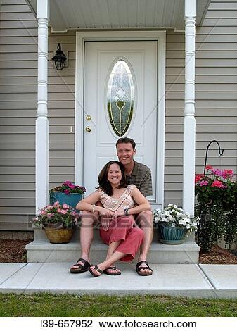 Couple sitting outside a condo in South Hadley, MA, USA. View Large Photo Image Stock Image - Couple sitting outside a condo in South Hadley, MA, USA.. Fotosearch