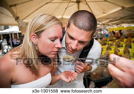 Couple smelling Italian herbs and spices View Large Photo Image Stock Photo - Couple smelling Italian herbs and spices. Fotosearch