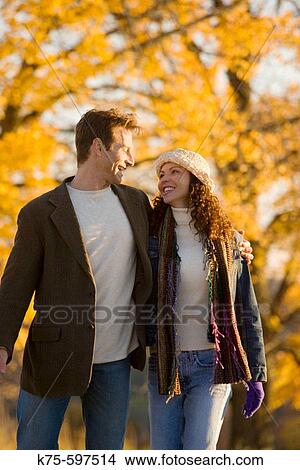 Couple smiling and walking in the country View Large Photo Image Picture - Couple smiling and walking in the country. Fotosearch