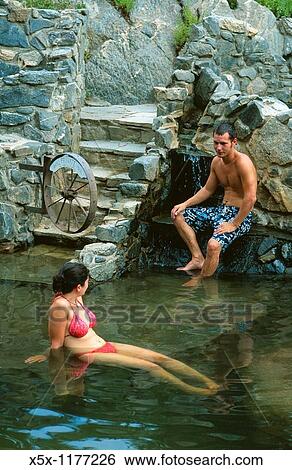 Stock Photograph - Couple soaking in Strawberry Park hot springs near Steamboat Springs, Colorado, USA. Fotosearch