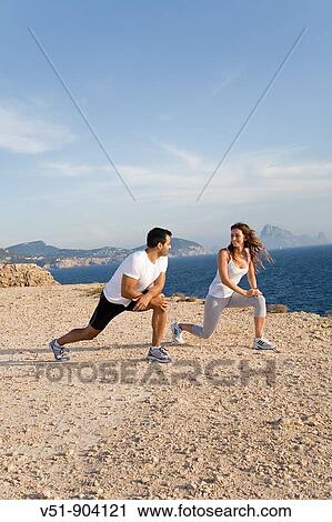 Couple Stretching by the sea View Large Photo Image Stock Image - Couple Stretching by the sea. Fotosearch