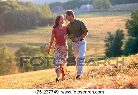 Stock Photo - Couple strolling arm in arm. Fotosearch