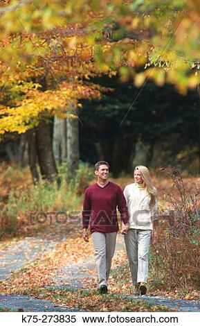 couple strolling on a country road in autumn View Large Photo Image Stock Photography - couple strolling on a country road in autumn. Fotosearch