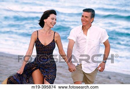 couple strolling on the beach View Large Photo Image Picture - couple strolling on the beach. Fotosearch
