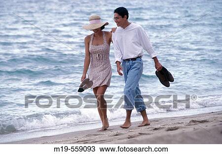 couple strolling on the beach View Large Photo Image Stock Image - couple strolling on the beach. Fotosearch