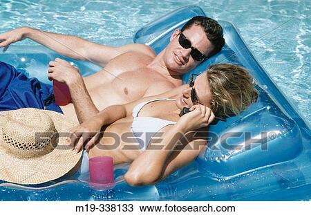 couple sunning in a pool View Large Photo Image Stock Image - couple sunning in a pool. Fotosearch