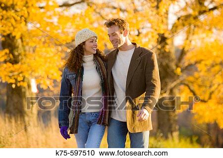 Couple taking a walk on a sunny autumn day View Large Photo Image Stock Image - Couple taking a walk on a sunny autumn day. Fotosearch