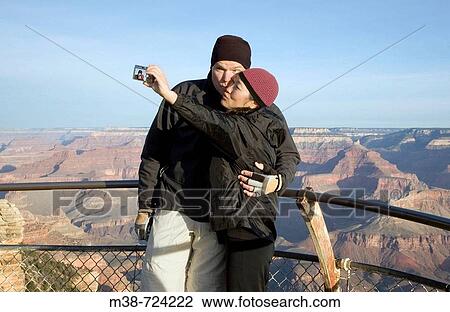 Couple taking picture of themselves, Grand Canyon, Arizona, USA View Large Photo Image Stock Image - Couple taking picture of themselves, Grand Canyon, Arizona, USA. Fotosearch