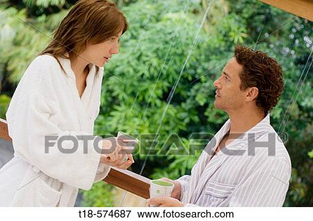 couple talking and drinking by glass wall View Large Photo Image Stock Photo - couple talking and drinking by glass wall. Fotosearch