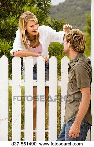 Couple talking to eachother with affection in the garden View Large Photo Image Stock Image - Couple talking to eachother with affection in the garden. Fotosearch