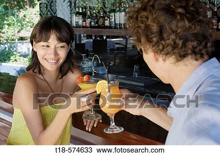 couple toasting at bar View Large Photo Image Stock Image - couple toasting at bar. Fotosearch