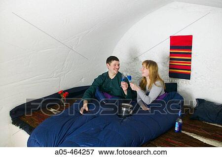 Couple toasting in a room of the igloo hotel. Hotel Kakslauttanen. Lapland. Ivalo. Finlandia View Large Photo Image Stock Photo - Couple toasting in a room of the igloo hotel. Hotel Kakslauttanen. Lapland. Ivalo. Finlandia. Fotosearch