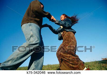 Couple twirling around in the country View Large Photo Image Stock Photograph - Couple twirling around in the country. Fotosearch