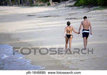 Couple walk hand in hand on deserted Mae Nam beach Ko Samui island Thailand View Large Photo Image Stock Photography - Couple walk hand in hand on deserted Mae Nam beach Ko Samui island Thailand. Fotosearch
