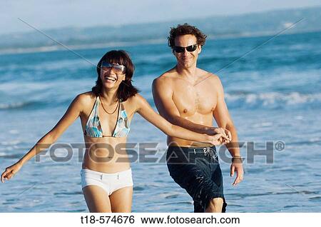 couple walking and sightseeing on beach View Large Photo Image Stock Photograph - couple walking and sightseeing on beach. Fotosearch