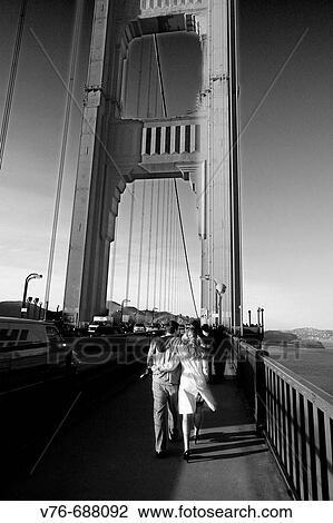 Couple walking at Golden Gate Bridge, San Francisco. California, USA View Large Photo Image Stock Image - Couple walking at Golden Gate Bridge, San Francisco. California, USA. Fotosearch