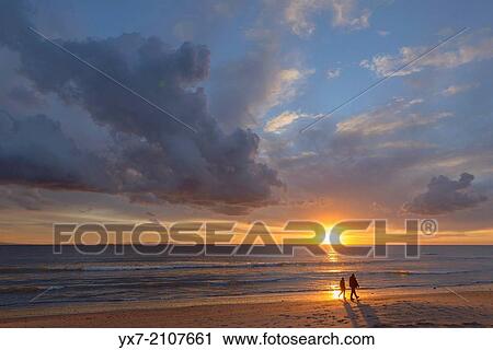 Couple walking at sunset. Tarifa, Costa de la Luz, Cadiz, Andalusia, Spain. View Large Photo Image Stock Image - Couple walking at sunset. Tarifa, Costa de la Luz, Cadiz, Andalusia, Spain.. Fotosearch
