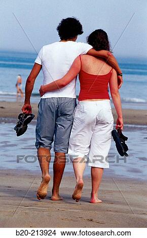 Picture - Couple walking by the beach. Hendaye. France. Fotosearch