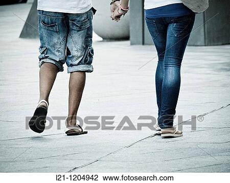 Couple walking down the street View Large Photo Image Stock Image - Couple walking down the street. Fotosearch