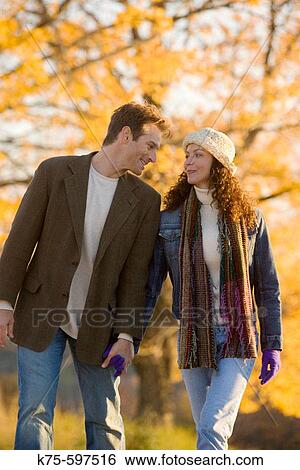 Stock Photograph - couple walking hand in hand. Fotosearch