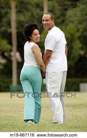 Couple walking hand in hand View Large Photo Image Stock Photograph - Couple walking hand in hand. Fotosearch
