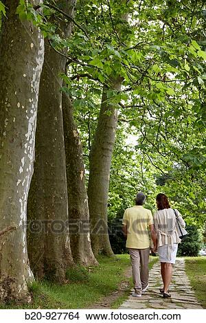 Couple walking in a garden, spa-relais. Lierganes hotel and spa, Cantabria, Spain View Large Photo Image Picture - Couple walking in a garden, spa-relais. Lierganes hotel and spa, Cantabria, Spain. Fotosearch