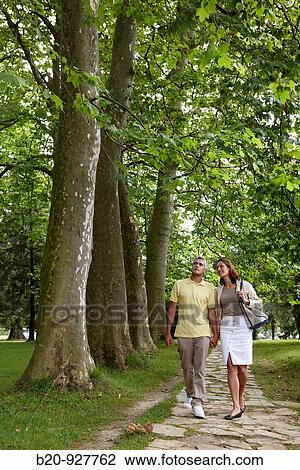 Couple walking in a garden, spa-relais. Lierganes hotel and spa, Cantabria, Spain View Large Photo Image Stock Image - Couple walking in a garden, spa-relais. Lierganes hotel and spa, Cantabria, Spain. Fotosearch