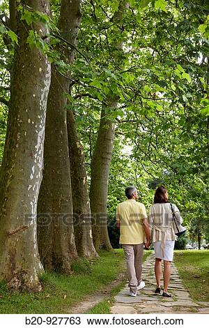 Couple walking in a garden, spa-relais. Lierganes hotel and spa, Cantabria, Spain View Large Photo Image Stock Image - Couple walking in a garden, spa-relais. Lierganes hotel and spa, Cantabria, Spain. Fotosearch