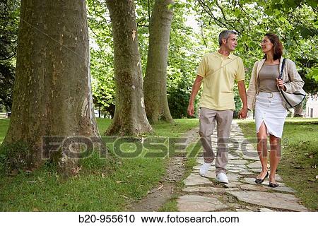 Couple walking in a garden, spa-relais. Lierganes hotel and spa, Cantabria, Spain View Large Photo Image Stock Image - Couple walking in a garden, spa-relais. Lierganes hotel and spa, Cantabria, Spain. Fotosearch