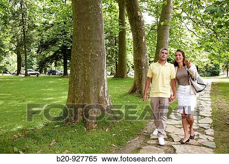 Couple walking in a garden, spa-relais. Lierganes hotel and spa, Cantabria, Spain View Large Photo Image Stock Photography - Couple walking in a garden, spa-relais. Lierganes hotel and spa, Cantabria, Spain. Fotosearch