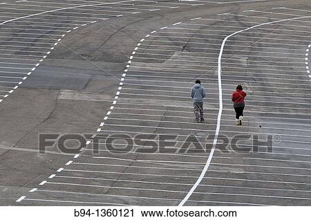 Couple walking in empty parking, La Molina ski resort, Girona province, Catalonia, Spain View Large Photo Image Stock Image - Couple walking in empty parking, La Molina ski resort, Girona province, Catalonia, Spain. Fotosearch