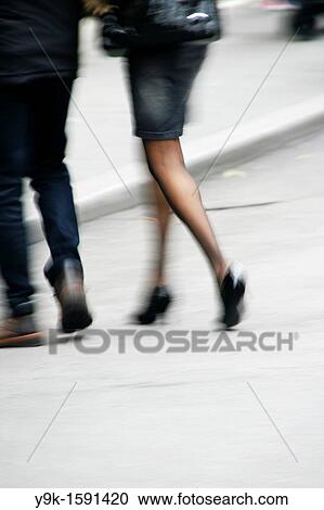Couple walking in street in city town View Large Photo Image Stock Image - Couple walking in street in city town. Fotosearch