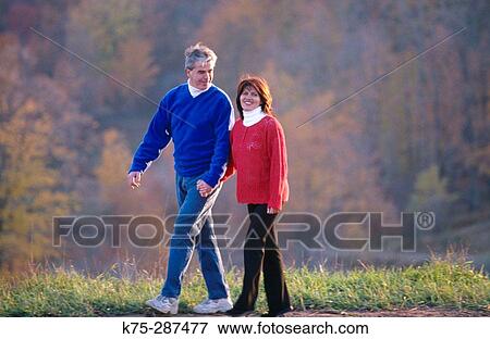 Couple walking in the country View Large Photo Image Stock Photo - Couple walking in the country. Fotosearch
