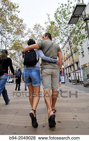 Stock Photo - Couple walking, La Rambla, Barcelona, Catalonia, Spain. Fotosearch