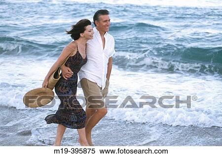 couple walking on a windy beach View Large Photo Image Stock Photography - couple walking on a windy beach. Fotosearch