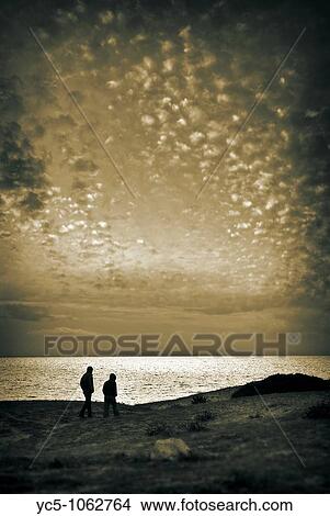 Couple walking on beach in winter View Large Photo Image Picture - Couple walking on beach in winter. Fotosearch