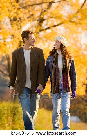 Couple walking on country road in the fall View Large Photo Image Stock Photography - Couple walking on country road in the fall. Fotosearch