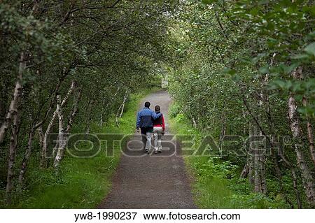Couple walking on path by Lake Myvatn, Iceland. View Large Photo Image Stock Photo - Couple walking on path by Lake Myvatn, Iceland.. Fotosearch