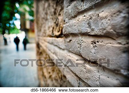 couple walking on the street near a brick wall. Valencia, Spain View Large Photo Image Stock Photograph - couple walking on the street near a brick wall. Valencia, Spain. Fotosearch