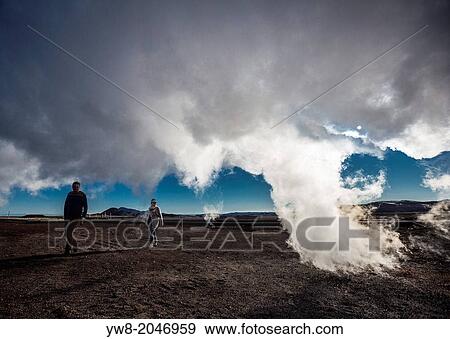 Couple walking under Geothermal Steam, Namaskard- Geothermal Volcanic area, Northern Iceland. View Large Photo Image Stock Photo - Couple walking under Geothermal Steam, Namaskard- Geothermal Volcanic area, Northern Iceland.. Fotosearch