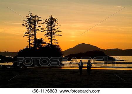 couple walks on the beach on Flores Island, BC, at sunset View Large Photo Image Stock Image - couple walks on the beach on Flores Island, BC, at sunset. Fotosearch