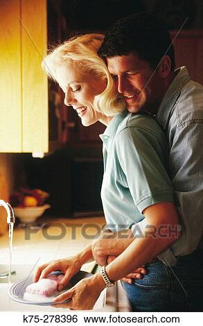 Couple washing dishes View Large Photo Image Stock Photograph - Couple washing dishes. Fotosearch