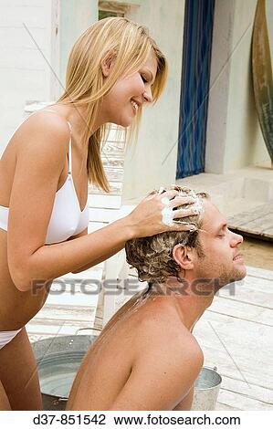 Couple washing hair with affection View Large Photo Image Stock Image - Couple washing hair with affection. Fotosearch