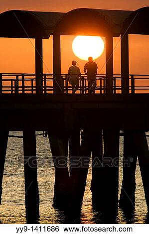 Couple watching sunset on pier- Jekyll Island, Georgia View Large Photo Image Stock Photograph - Couple watching sunset on pier- Jekyll Island, Georgia. Fotosearch