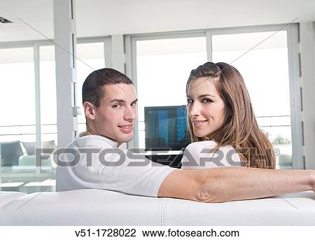 Couple watching TV at home View Large Photo Image Stock Image - Couple watching TV at home. Fotosearch
