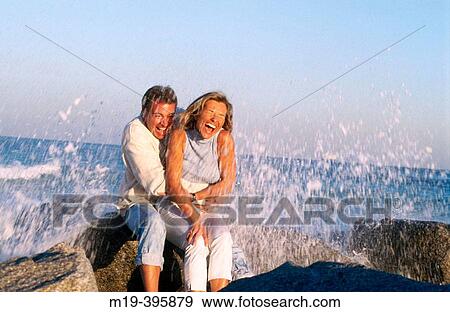 couple with a wave splashing over them View Large Photo Image Stock Photo - couple with a wave splashing over them. Fotosearch