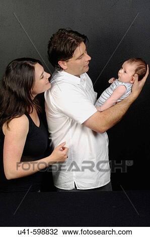 Stock Image - Couple with baby.. Fotosearch