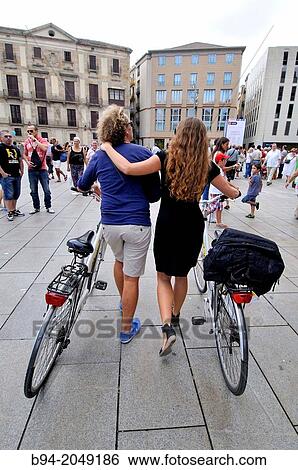 Couple with bicycle at Pla? a Nova, Barcelona, Catalonia, Spain View Large Photo Image Stock Photograph - Couple with bicycle at Pla? a Nova, Barcelona, Catalonia, Spain. Fotosearch